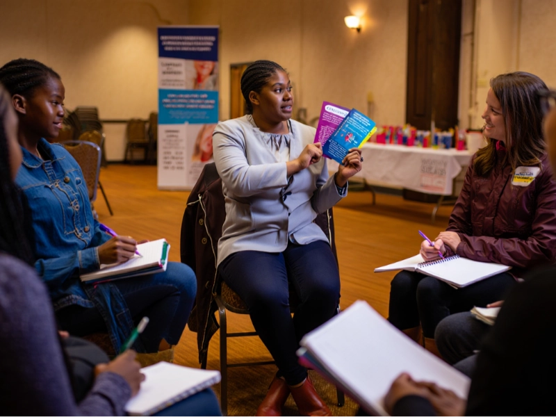 picture of advisor showing people leaflets